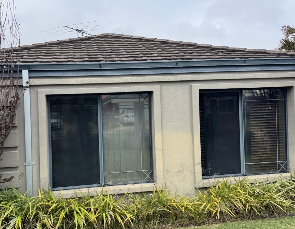 Gwelup front elevation before works, showing stained and weathered render